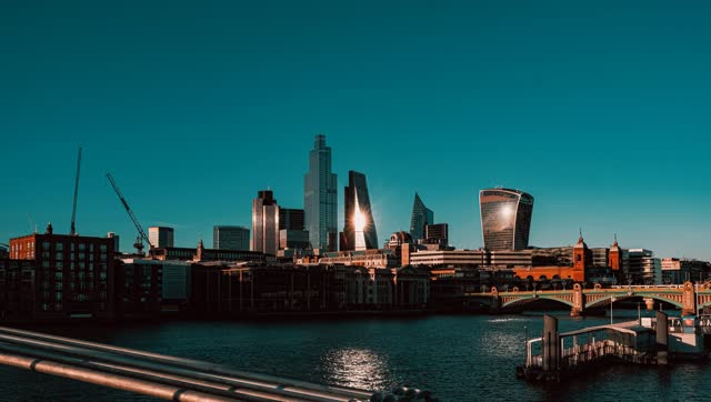 The City of London skyline with sun flare over the Thames